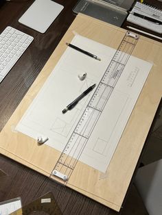 a wooden table topped with lots of different types of tools and paper on top of it