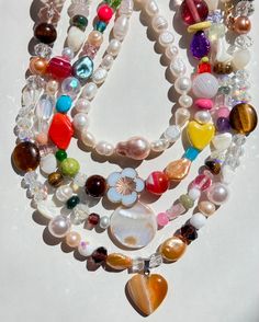 Fixing our sweet tooth with these Organic BONBON Candy Necklaces! This special series is handmade with all semi-precious and precious stones such as natural agates, tiger’s eye gemstone, mother of pearls, and vintage glass beads we collect over the years. We will add new pieces from time to time! Limited quantities for these healthy "sweets" (Not actually edible, of course).  All necklaces measure at about 16" long with a gold-plated circle clasp. Clutter Necklace Y2k, Cool Pearl Necklace, Colorful Necklace Stack, Cool Beaded Necklaces, Glass Beaded Necklace, Craft Moodboard, Chunky Beaded Necklace, Mismatched Jewelry, Y2k Designs