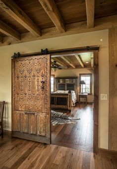 an open wooden door in the middle of a room