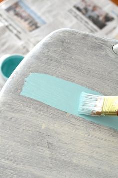 a paintbrush sitting on top of a wooden table