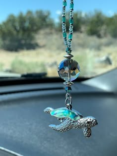 a car dashboard with a turtle charm hanging from it's side