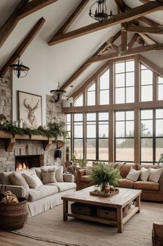 a living room filled with furniture and a fire place in front of a large window