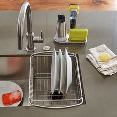 a kitchen sink filled with dishes next to a faucet