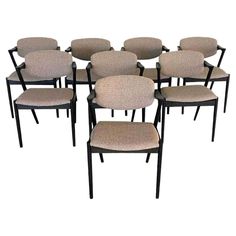 six dining chairs with beige upholstered back and seat cushions, set of eight