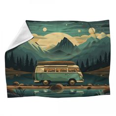 a camper van parked on the side of a road with mountains in the background