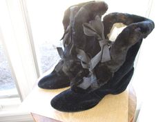 Gorgeous antique Victorian carriage boots or sleigh boots featuring black velvet, fur, original satin ribbons, and silk (?) quilted liner. The boots are in remarkable condition when you consider their age. The boots date back to approximately 1890's. The boots are small and have a leather sole. The sole is in very good condition. There is no "lifting" from the base. Their ribbons show a little wear because they are original.  There is light wear inside. The heel has an open space where the heels to the slipper would fit so that they didn't have to remove their shoes. Inside the boots, they are signed "BECK" "5 1021's". On one boot, towards the bottom, close to the "tongue" the fur is lifting a little. I am leaving this "AS IS" as I don't know how to properly fix it. there is a photo of it. Victorian Black Boots For Formal Occasions, Black Victorian Boots For Formal Occasions, Vintage Formal Boots For Winter, Victorian Carriage, Victorian Boots, Satin Ribbons, Costume Collection, Beautiful Boots, Ribbon Tie