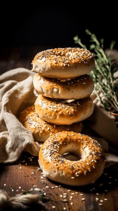 a stack of bagels sitting on top of a wooden table