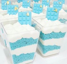 there are many blue and white cakes in plastic containers