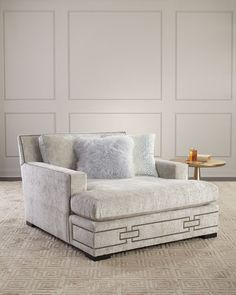 a white chair sitting on top of a carpeted floor next to a coffee table