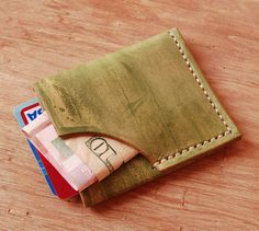 three credit cards sticking out of an empty wallet