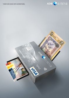 a silver credit card sitting on top of a stack of money