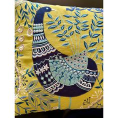 a decorative pillow with a bird on it