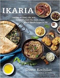 a cookbook with food on it sitting on top of a wooden table next to a fork