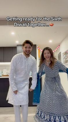 a man and woman standing next to each other in front of a kitchen counter top