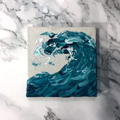 an abstract painting of a wave in blue and white on a marble wallpapered surface