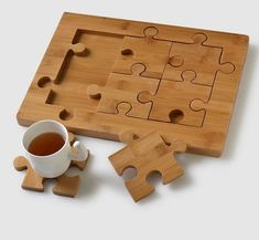 a cup of tea and puzzle pieces on a table