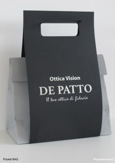 a black paper bag with the words de pato printed on it's side