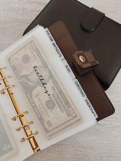 a notepad with money and a clipboard attached to it sitting on a table