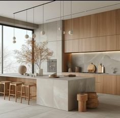 a modern kitchen with marble counter tops and stools next to a large window that looks out onto the outdoors