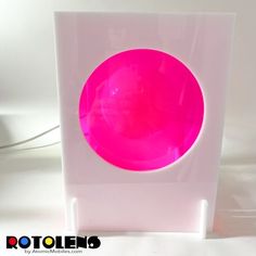 a pink light sitting on top of a white box