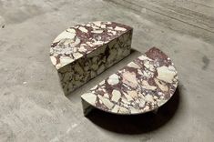 a marbled object sitting on top of a cement floor