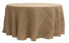 a round table with a beige linen cover