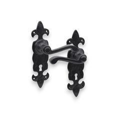 two black iron door handles on a white background, one has an ornate design and the other is shaped like a dog