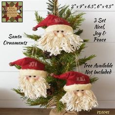 three santa ornaments hanging from a christmas tree with the names noel, noel and peace