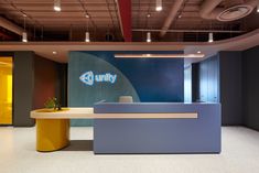 an office lobby with blue and yellow accents