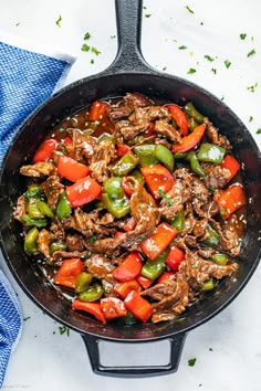 a skillet filled with beef and peppers