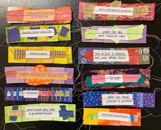 several pieces of colorful paper with words on them and some string attached to the sides