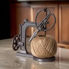 a ball of yarn and a sewing machine on a table