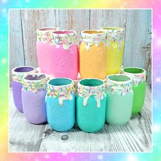 the mason jars are painted with pastel colors