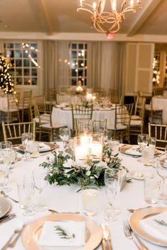 the table is set with candles and place settings