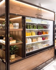 a display case filled with lots of different types of juices and condiments