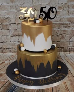 a 50th birthday cake with gold and black decorations