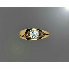 a yellow gold ring with a diamond in the center