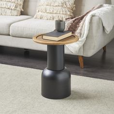 a coffee table with a book and cup on it