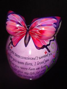 a purple vase with a pink butterfly on it's side and a poem written in the bottom