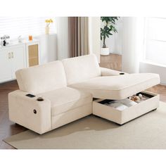 a white sectional sofa with storage underneath it