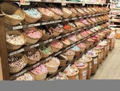 the shelves are filled with many different kinds of candy and candies in buckets