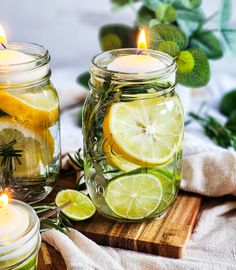 two mason jars filled with lemons and lime slices