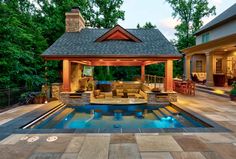 an outdoor living area with a pool and gazebo