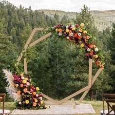 an outdoor ceremony setup with flowers and greenery