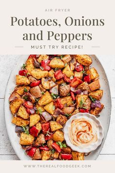 potatoes, onions and peppers on a white plate with the title overlay reads air fryer potatoes, onions and peppers must try recipe