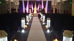 the aisle is decorated with candles and flowers