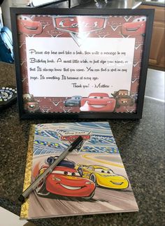 a birthday card with cars on it next to a framed photo and a pen that says, you are not able to look in the mirror