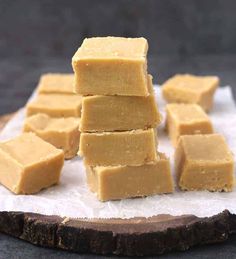 several pieces of peanut butter fudge sitting on top of a piece of parchment paper