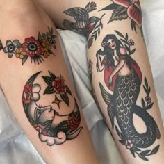 two mermaid tattoos on both legs, one with a fish and the other with flowers