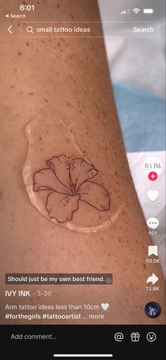 a woman's arm with a tattoo on it that has a flower in the center